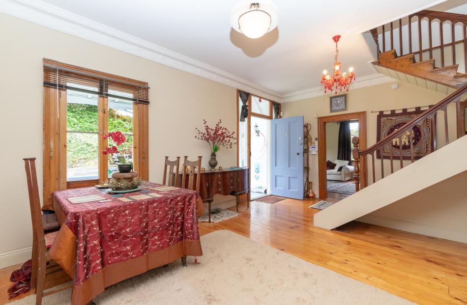 The lounge incorporates the original front hall, showing off the central curved staircase to full...