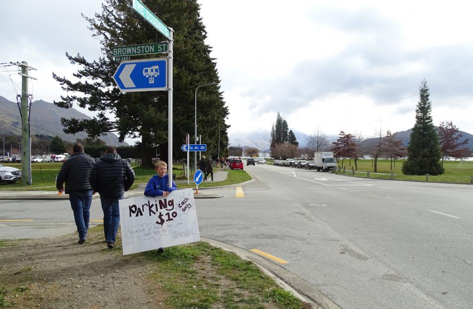 Dominic Plimmer (11), of Wanaka, advertises parking for the match. 