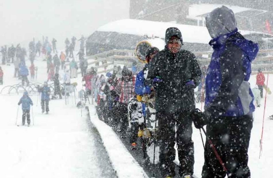 People enjoying the slopes as snow finally falls on the ski fields around Queenstown.