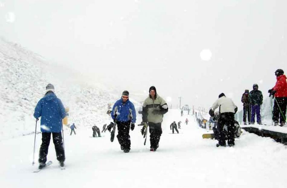 People enjoying the slopes as snow finally falls on the ski fields around Queenstown.