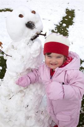Arrowtown's 2-year-old Ivy Jackson with her snowman in Arrowtown.