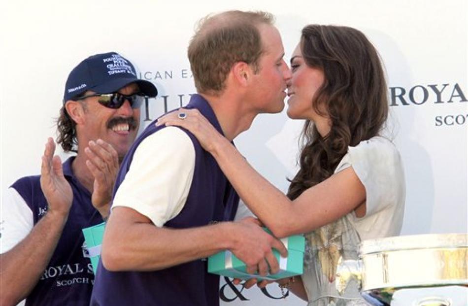 Prince William kisses his wife after his team, Royal Salute, won the Foundation Polo Challenge at...