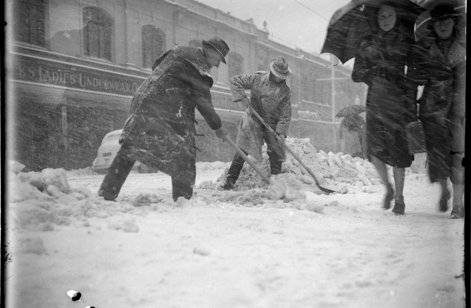 Men clear snow from footpaths and the road in George St, Dunedin. PHOTO: EVENING STAR