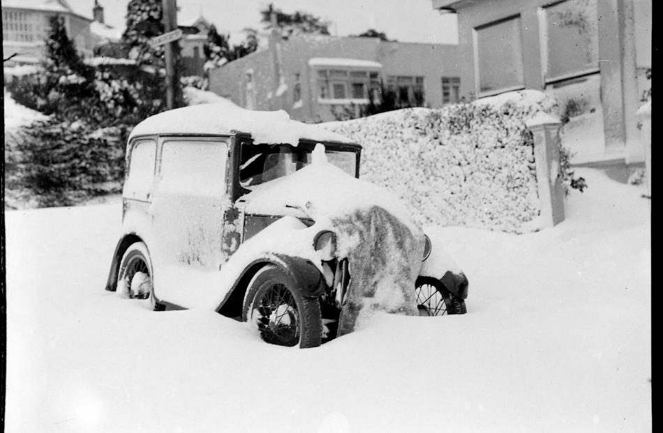 A car is buried under snow, which blocked most streets around Dunedin. PHOTO: EVENING STAR