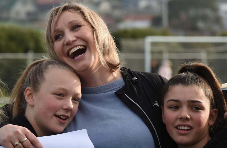 Fairfield School coach Lea Jones hugs pupils Charlie Grace-Gallagher (left) and Sarah Donaldson ...