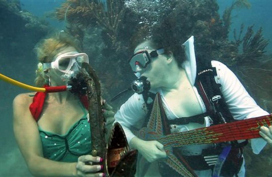 Samantha Langsdale, left, as a mermaid, and Eric Rolfe, as 'Eel-vis Presley', at the Lower Keys...