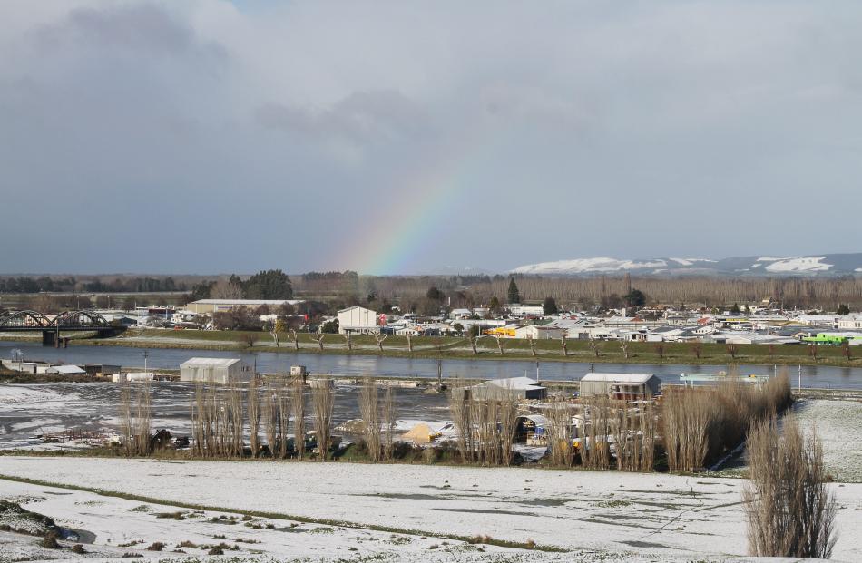 Looking eastwards towards  the Catlins showing rainbow over snow covered Balclutha and how low the snow fell near the coast. Photo: John Consgrove