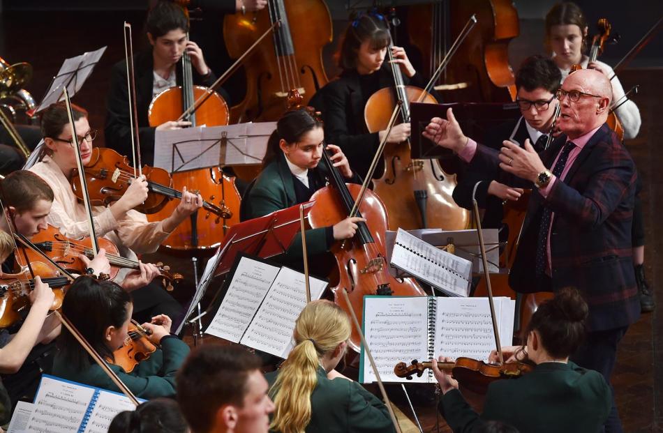 Conductor Richard Madden keeps a combined choir and ensemble in sync.