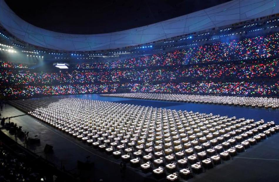 Performers light up their drums during the opening ceremony. (AP Photo/Itsuo Inouye)