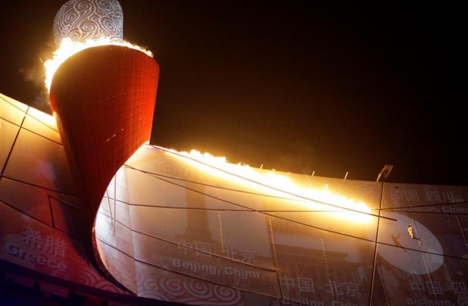 Former Chinese Olympian Li Ning lights the Olympic flame. (AP Photo/David Guttenfelder)