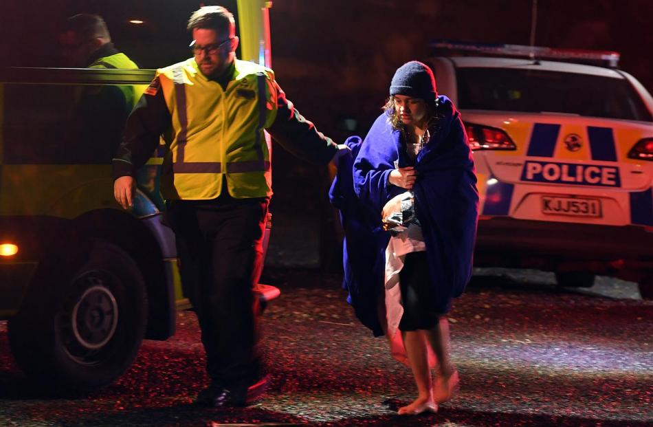 A female passenger is helped to an ambulance