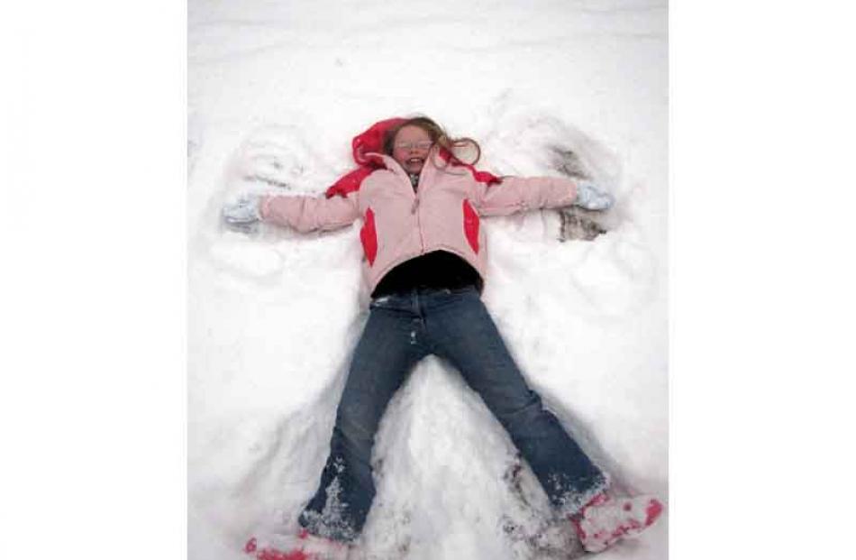 Caitlin Tipping (8), of Rangiora, made snow angels in Arrowtown yesterday morning. Photo by...