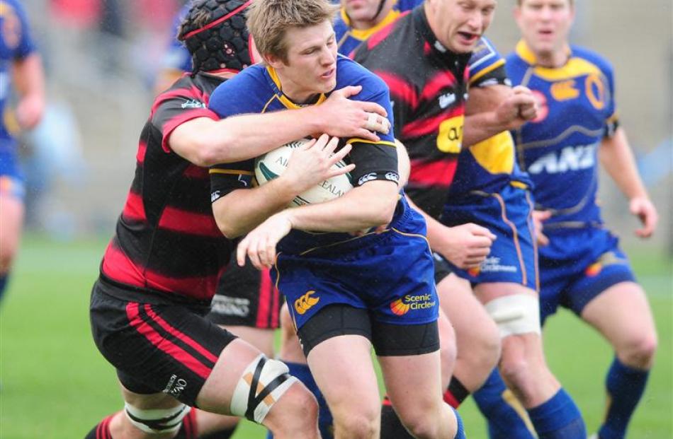 Otago's Toby Morland is caught by the Canterbury defence. Photo by Craig Baxter