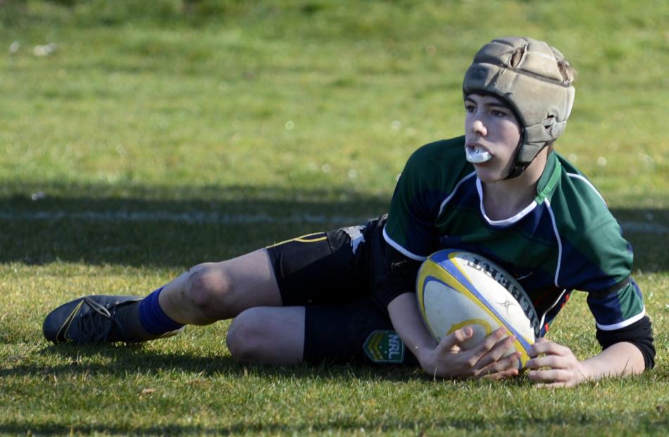 Tahuna Normal Intermediate year 8 pupil Joel Cook (13) scores a try for his side at the...