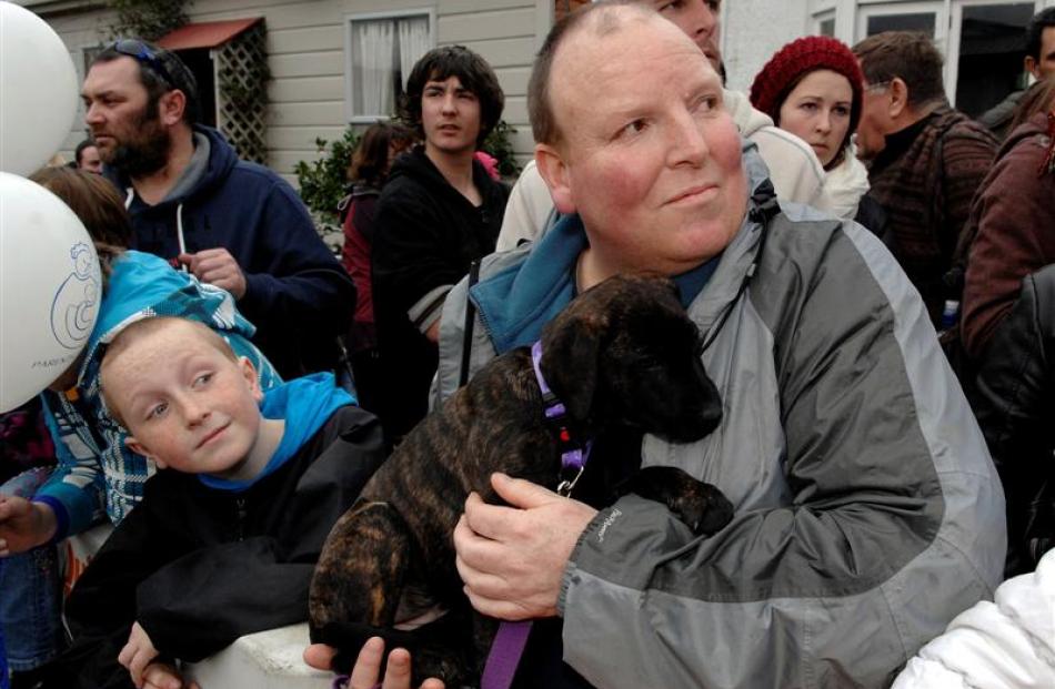 Dylan Murcott (9), his father Warren and their puppy Seeker wait patiently for the Jaffas to come...