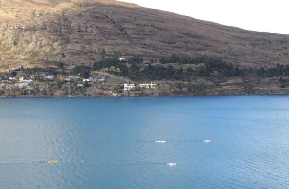 Kayakers are dwarfed by the lake and mountains of Frankton Arm.