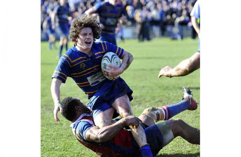 Taieri number 20 Ryan Hammer is tackled by Harbour number 12 Lex Kaleca.
