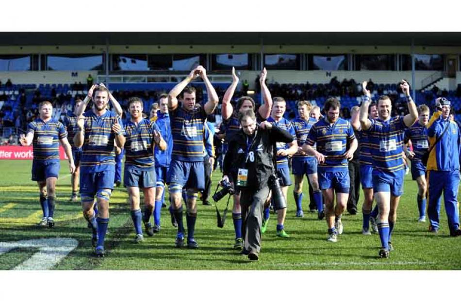 Taieri celebrate their premier club rugby final win as ODT photographer Craig Baxter works his...