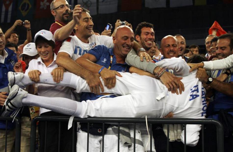 Italy's Matte Tagliariol jumps into the crowd after beating Fabrice Jeannet of France during the...