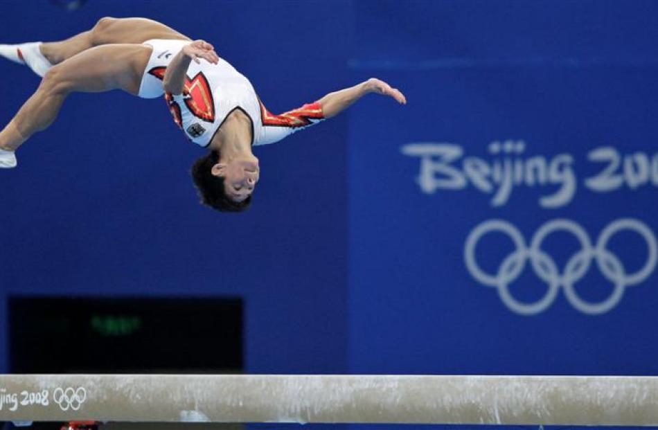 German gymnast Oksana Chusovitina performs on the balance beam during the women's qualification...