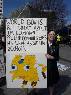 Rangiora High School student Holly Whittaker with her sign at the protest. Photo: Claire Booker