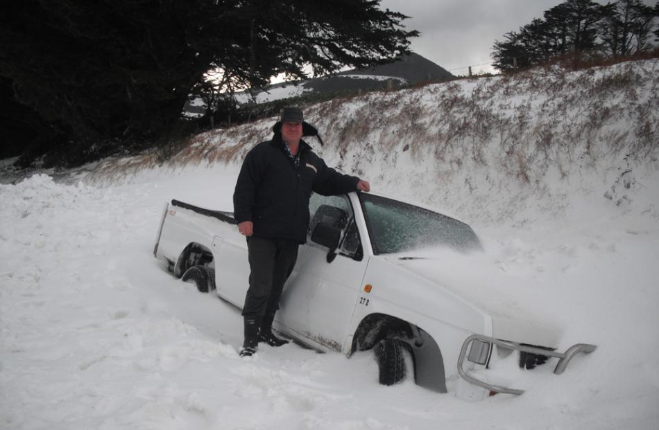 A car is stuck in a snow drift on Purakanui Road. Photo by Lionel Carr.