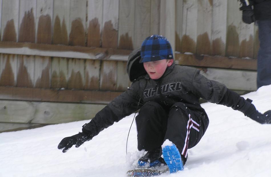 Ben Jones slides down a hill in Waverley. Photo by Glenda Paterson.