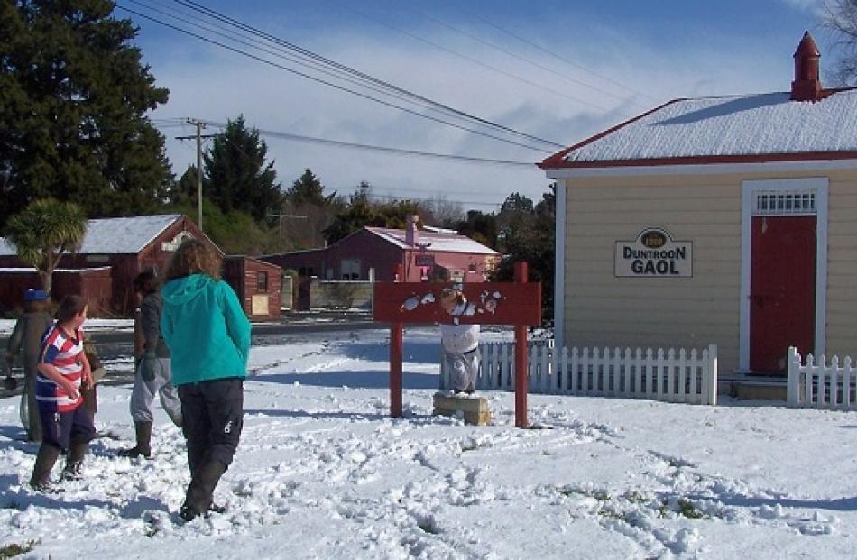 Duntroon resident Zara Trusler takes a pelting from friends while in the stocks at the historic...