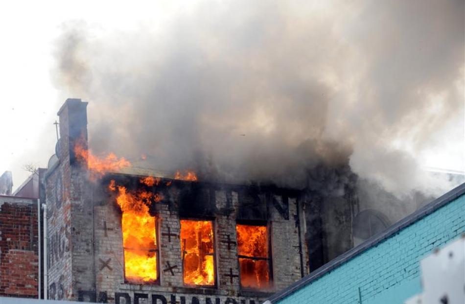 Flames and smoke visible at the rear of the building.