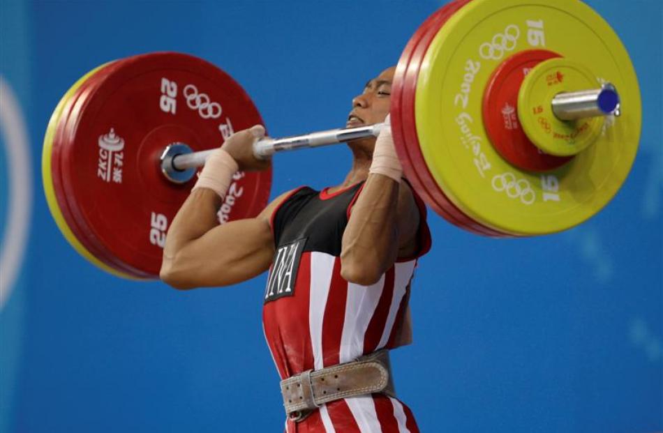 Triyatno of Indonesia jerks 163kg to win the bronze medal of the men's 62 kg category of the...