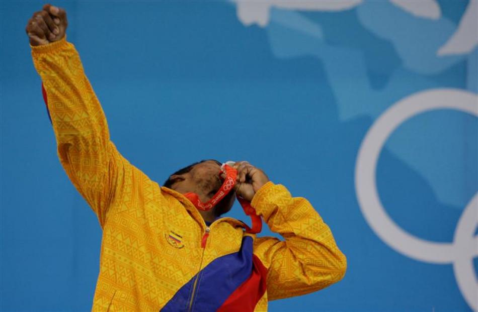 Diego Salazar of Colombia kisses his silver medal at the podium of the men's 62kg category of the...