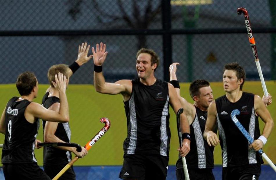 New Zealand's Hayden Shaw, centre, celebrates after scoring against Korea during their men's...