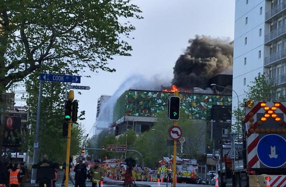 Flames and smoke continued to pour forth from the building this morning. Photo: RNZ