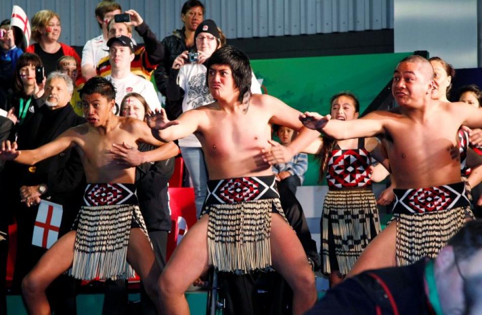 A Kapa haka group performs as England arrives at Auckland airport this morning.