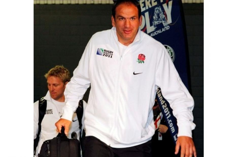 England coach Martin Johnson emerges into the arrivals area at the airport.