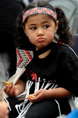 Jade Taani (3), from Early Learning on London, has a snack while enjoying the  action.