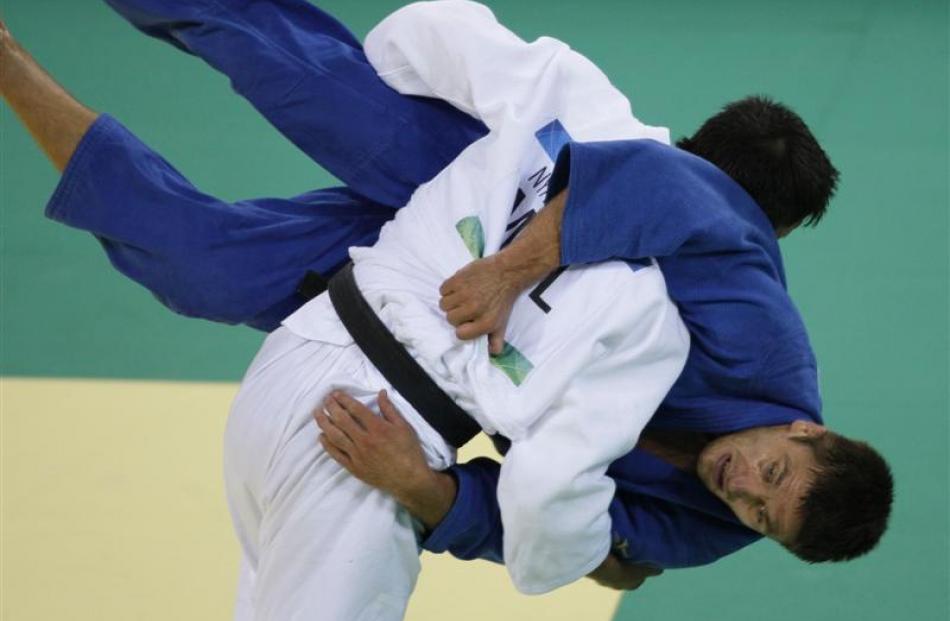 Mongolia's Nyamkhuu Damdinsuren throws Poland's Robert Krawczyk to win their men's under 81 kg...