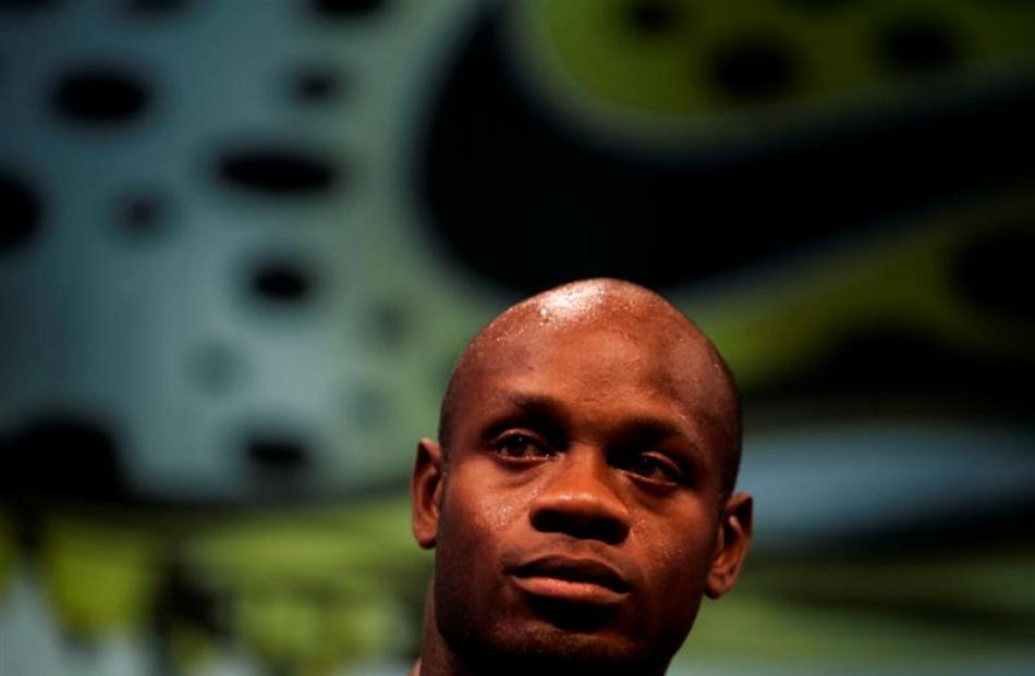 Former track and field 100m sprint record holder Asafa Powell pauses during a press conference in...