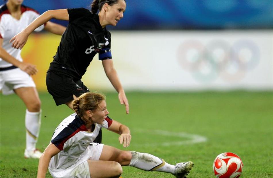 Lori Chalupny, of the US, fights for the ball with New Zealand's Hayley Moorwood. (AP Photo...