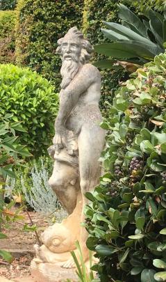 A mixed shrubbery enhanced by a standing figure. 