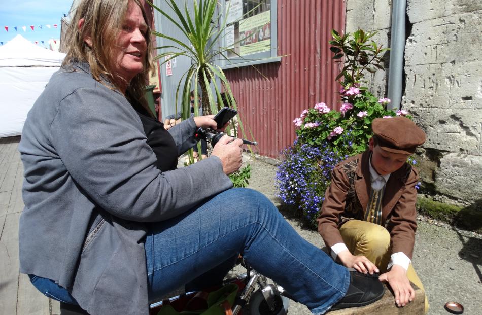 Jenny Tebbott, of Whakatane, has her shoes shined by Oamaru’s Elliott Mackenzie (13).