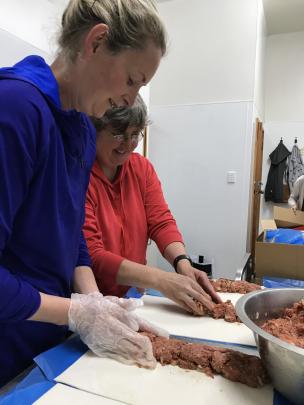 Emily Jones (left) and Trudy Lindsay begin an assembly line.