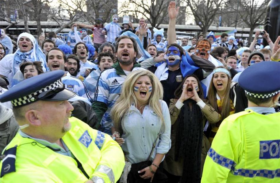Police keep chanting English and Argentinian fans separate as the two teams of supporters...