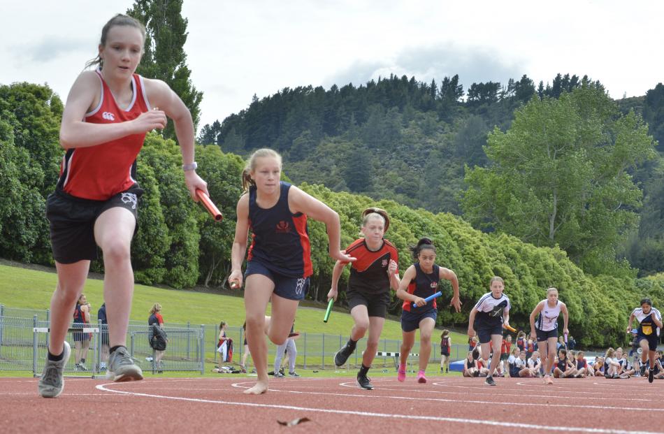 The first leg of an under-13 girls 200m relay heat. PHOTOS: GERARD O'BRIEN