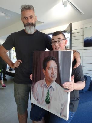 Artist Stephen Martyn Welch with his son Scott and his portrait of Paul Tamati.  PHOTO: MARK PRICE
