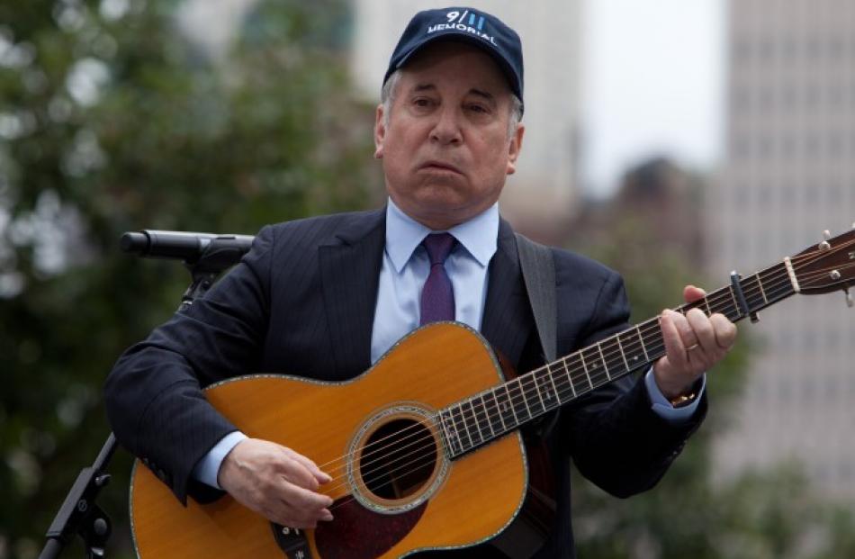 Paul Simon performs during ceremonies marking the 10th anniversary of the 9/11 attacks on the...