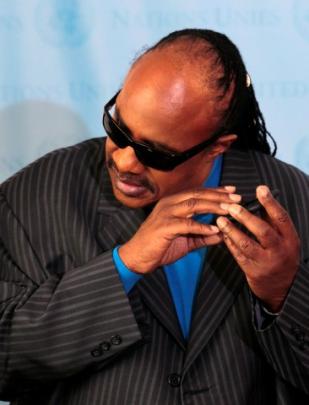 Singer Stevie Wonder uses a smartphone while unveiling the United Nations Mobile Application at...
