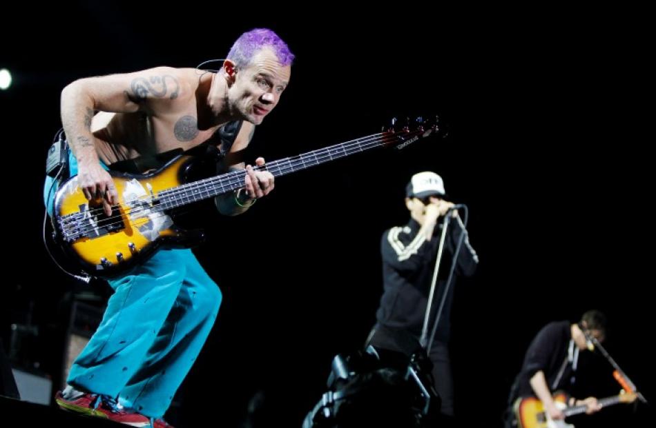 Red Hot Chili Peppers bassist Flea(L) and lead singer Anthony Kiedis perform during their world...