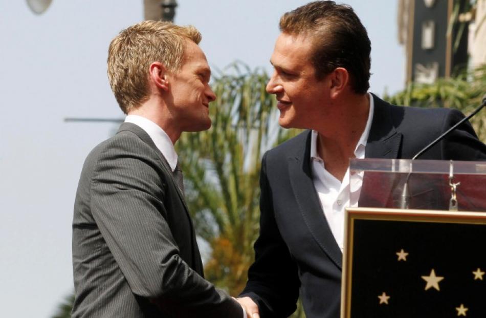 Actor Neil Patrick Harris (L) is congratulated by actor Jason Segel, his co-star on their TV...