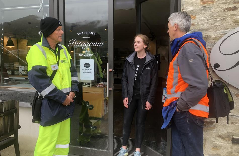 Queenstown Lakes district emergency management officer Trevor Andrews and Deputy Mayor Calum MacLeod talk with Kate Donaldson, an employee at Patagonia Chocolates, one of the businesses in the flood risk area of Wanaka lakefront they visited yesterday aft